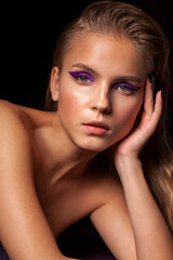 young blond fashion model with bright make up