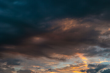 Naklejka na ściany i meble Dramatic or cinematic clouds at sunrise. Morning cloudscape.