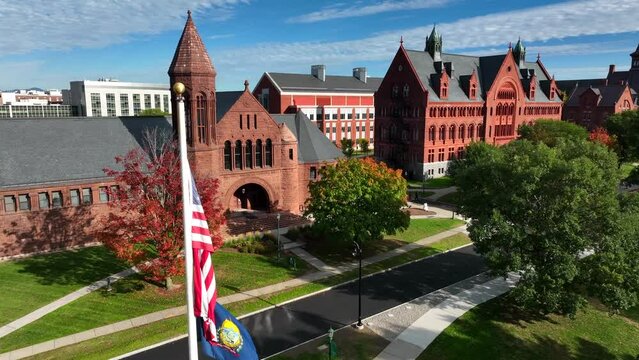 University of Vermont aerial establishing shot with USA and VT flags. College campus in Burlington VT.