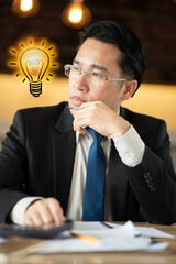 Asian business man having a good idea. A lighted light bulb. new idea, thinking, innovation, creative, plan strategy and solution concept.