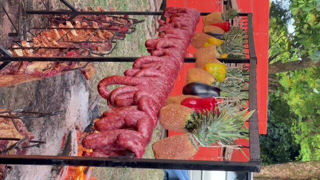 Brazilian Barbecue, rib, meats on ground fire.Vertical position of the video.