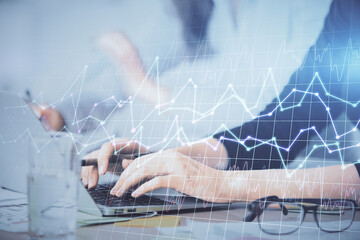 Multi exposure of woman hands typing on computer and financial graph hologram drawing. Stock market analysis concept.