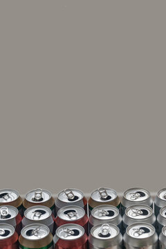 Cover page with a group of empty aluminum beer cans standing in order for recycling. Concept of recycling metal and plastic with copy space and grey solid background