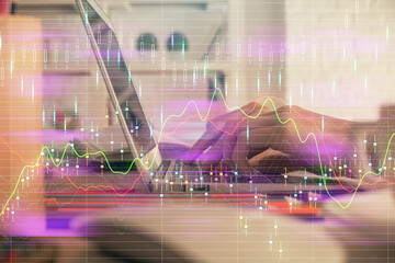 Double exposure of woman hands typing on computer and forex chart hologram drawing. Stock market invest concept.