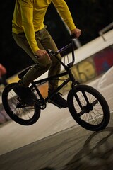 Vertical shot of a man on a stunt bike