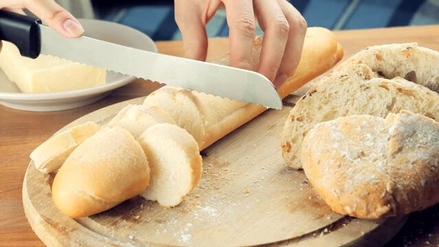 cutting bread on kitchen. fresh bread. french baguette