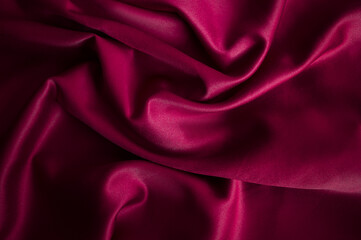 Smooth elegant magenta pink color silk or satin luxury cloth fabric texture, abstract background design.