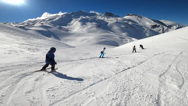 Kids learning how to ski with the ski instructor in the mountains