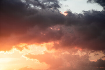 Obraz premium Dramatic clouds formations during a colorful sunset after a summer storm