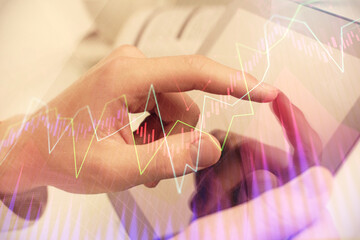 Multi exposure of man's hands holding and using a phone and financial chart drawing. Market analysis concept.
