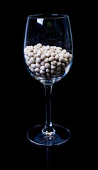 raw white beans in glass jar, wine glass. in bucket. raw white beans on black background. front...