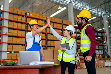 Fototapeta na wymiar Warehouse manager woman clap hands with her co-worker to express successful of the project and also cheer up with the member in workplace.