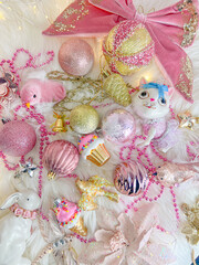 Christmas composition. Christmas balls, pink and gold decorations background. Flat lay, top view, copy space.