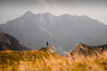 A hiker is enjoying the view from a cliff in the Orobie Alps, Northern Italy © Stefano Dosselli