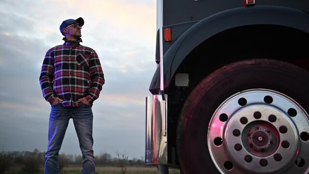 Caucasian Semi Truck Driver in His 40s Staying in Front of His Truck Tractor