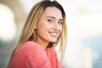 Close up smiling young woman with blond hair and blue eyes