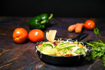 Vegetarian restaurant dishes top view, hot spicy indian soups, rice and salads in bowls. Traditional indian cuisine meal assortment on wood background