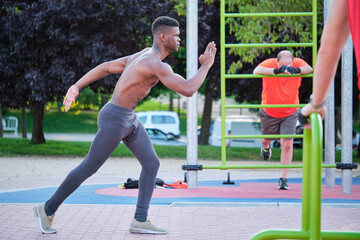Young fit shirtless black man ready to run outdoors on sunny summer day. Fitness and sport...