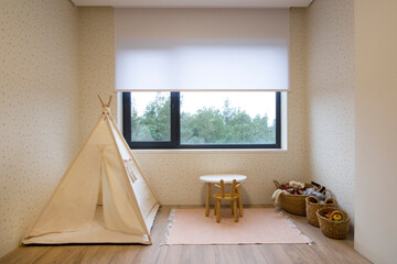 Interior of child's room. Roller blinds in the children's room. Automatic roller shades on the...