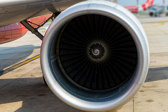 Close-up of a turbine engine of a passenger plane in an airport parking