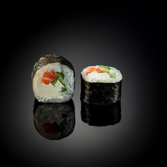 Japanese sushi with seafood with reflection on black background. Poster sushi bar menu photo concept
