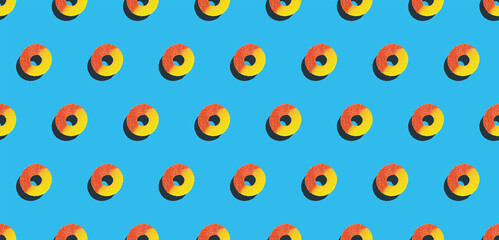 Peach Ring Gummy Candy Pattern on Blue Background - Flat Lay Image