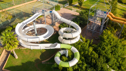 Aerial view on the white slides of a water park. The attraction is empty.
