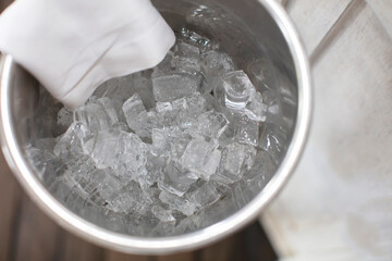 Fototapeta na wymiar Square pieces of ice in a bucket for cooling alcoholic beverages.