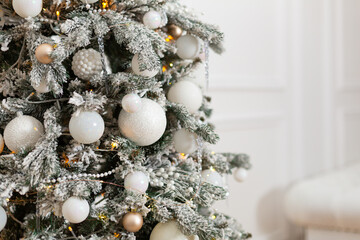 Fototapeta na wymiar White decorated Christmas tree against wall copy space