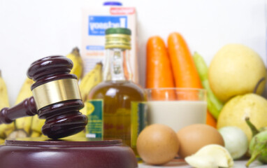 Consumer protection act concept.Gavel judge with food background.
