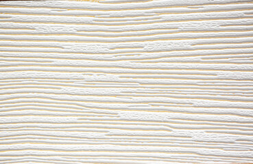 Brown background from decorative plaster with abstract spots. Unusual beige wall texture with beautiful patterns, creative surface background. Front covering for facing of buildings.