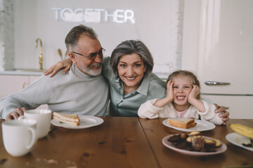 Happy family having fun together during breakfast