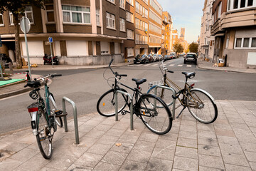 Fototapeta na wymiar Three conventional bikes locked onto a bicycle rack in the street in Brussels