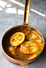 Egg Curry or Anda masala gravy, baida curry. Indian spicy food. Indian nonvegetarian Homemade food. Perfect Indian lunch. over moody background with copy space.