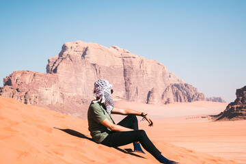 man in the desert wadi rum jordan with scarf - obrazy, fototapety, plakaty