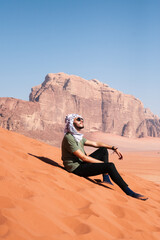 man in the desert wadi rum jordan with scarf