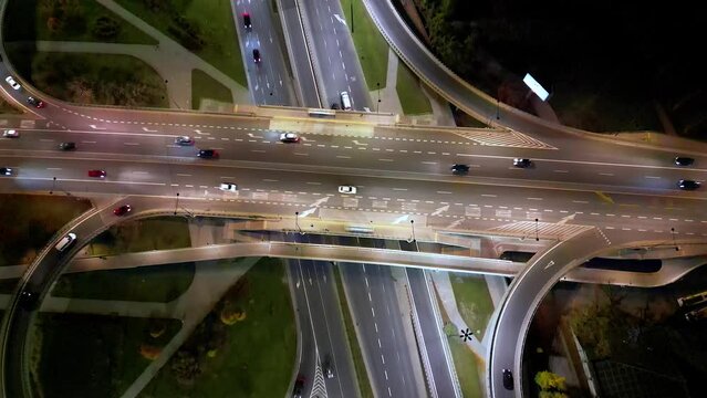 Aerial night view of empty highway and interchange Warsaw Europe after epidemic lockdown. Cityscapes with disappearing traffic on streets. Roads and lanes crossroads
