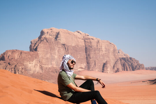 man in the desert wadi rum jordan with scarf