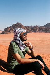 man in the desert wadi rum jordan with scarf