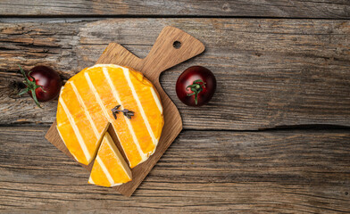 cream Round brie or camambert cheese on a wooden background. Long banner format
