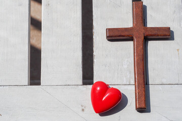 Red heart, wooden Jesus cross on plank. Concept Jesus loves you, Jesus crucify himself with love....