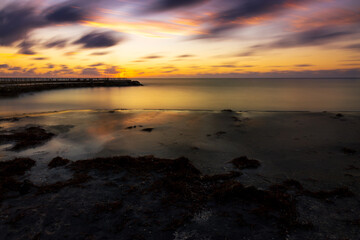 colorful long exposure of the jetty at the jupiter inlet in jupiter florida.
