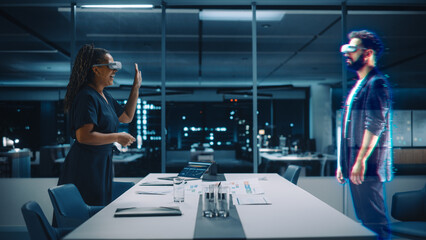 Future Office Online Meeting Video Conference Call: Businesswoman and Businessman Wearing Virtual Reality Glasses Talk using Augmented Reality Metaverse. Hologram Concept of Virtual Work Simulation