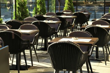 Fototapeta na wymiar Street cafe empty tables on the outdoor terrace