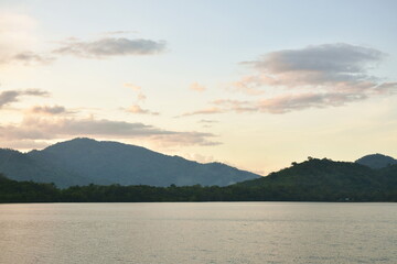 landscape of water reservoir lake with mountain background in sunset