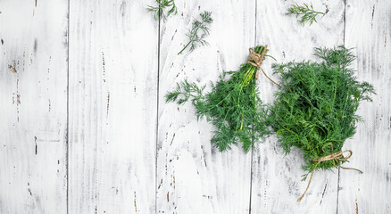 Fresh dill close up on wooden box on dark background, preparation for freezing serving size organic healthy ething natural product portion. Long banner format. top view