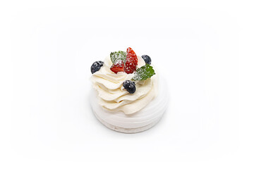Meringue dessert Pavlova mini cake with fresh strawberries, blue