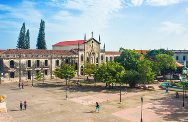Beautiful panoramic view of La Asunción school and chapel in the colonial city of León, Nicaragua. A quiet afternoon in the central park of León. City landscape with people walking in the park.