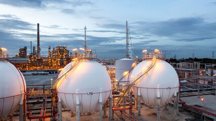 Gas storage sphere tank in petrochemical industry zone with oil and gas refinery factory plant petrochemical industry and oil storage tank background, Oil refinery at twilight.