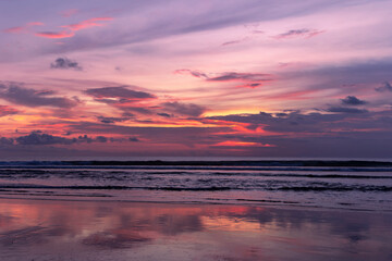 Naklejka na ściany i meble Beautiful colorful sunset over the Indian Ocean in Bali, Indonesia. Desktop wallpaper. Nature. Travel concept.